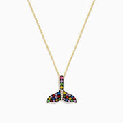 The Watercolors 14K Yellow Gold Multi Sapphire and Diamond Tail Pendant is a chain necklace with a whale tail design, featuring multicolored sapphires and diamonds set in a striking pattern, shown on a white background.