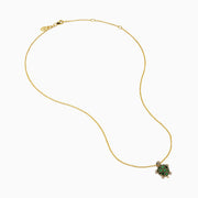 The 14K Yellow Gold Tsavorite and Diamond Turtle Pendant features a turtle-shaped design with a shell adorned in vibrant green tsavorites and sparkling diamonds on its head and feet, set against a plain white background.