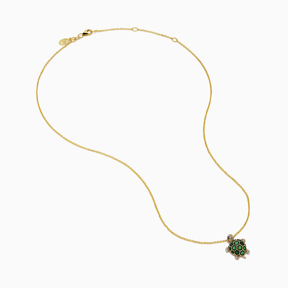 The 14K Yellow Gold Tsavorite and Diamond Turtle Pendant features a turtle-shaped design with a shell adorned in vibrant green tsavorites and sparkling diamonds on its head and feet, set against a plain white background.