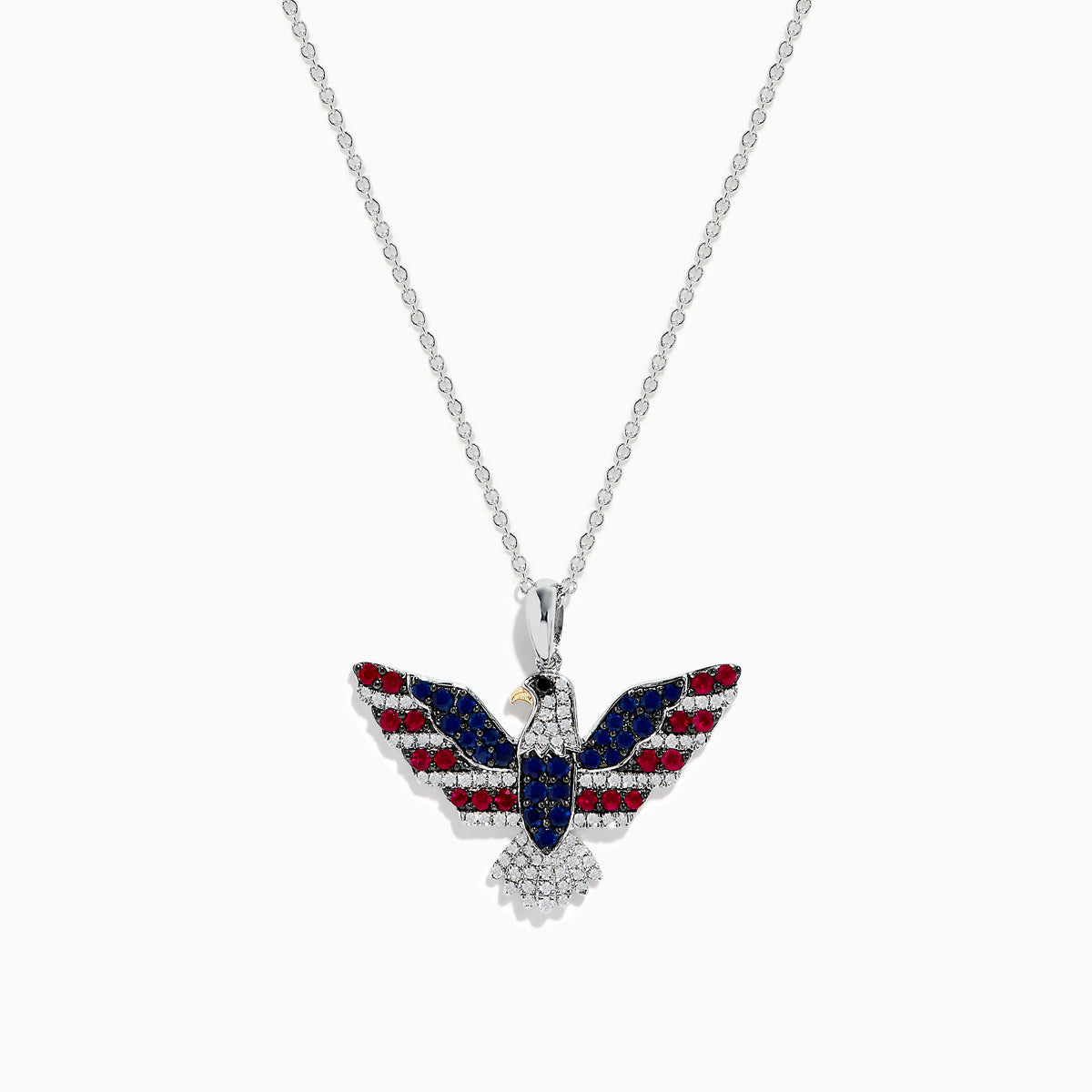The Sterling Silver Black and White Diamond, Ruby and Sapphire Pendant features an eagle in flight with gemstones artfully arranged to evoke the American flag.