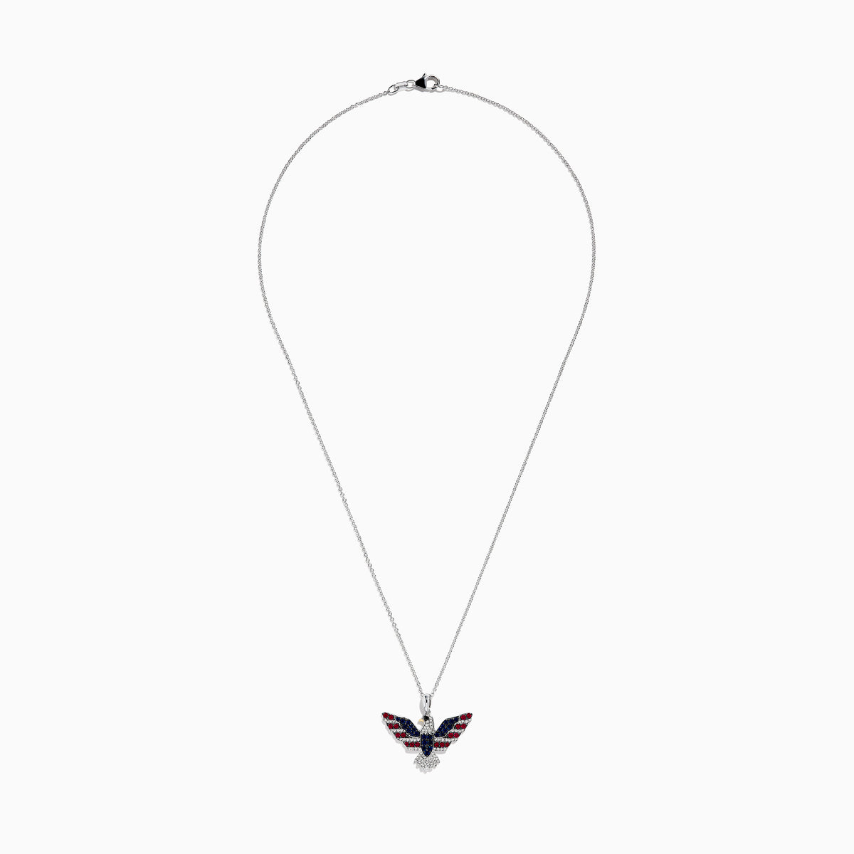 The Sterling Silver Black and White Diamond, Ruby and Sapphire Pendant features an eagle in flight with gemstones artfully arranged to evoke the American flag.