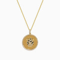 Signature 14K Yellow Gold Diamond and Emerald Panther Pendant features a round medallion with sparkling diamonds, emerald accents, and a delicate gold chain. Displayed against a white background.