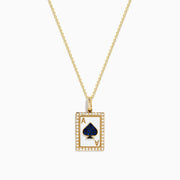 The Casino 14K Yellow Gold Diamond and Sapphire Spade Card Pendant is a yellow gold necklace with a rectangular ace of spades design, diamond accents, and a large sapphire blue spade in the center.