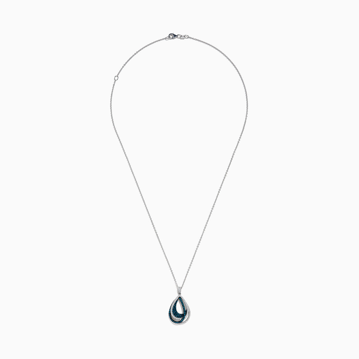 The 14K White Gold Blue and White Diamond Pear Crossover Pendant features blue and white diamonds in a swirling pattern, set on a delicate chain for a modern, intricate look.