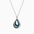 The 14K White Gold Blue and White Diamond Pear Crossover Pendant features blue and white diamonds in a swirling pattern, set on a delicate chain for a modern, intricate look.