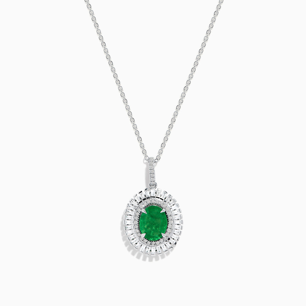 A 14K white gold pendant featuring an oval emerald, surrounded by a double halo of sparkling diamonds.
