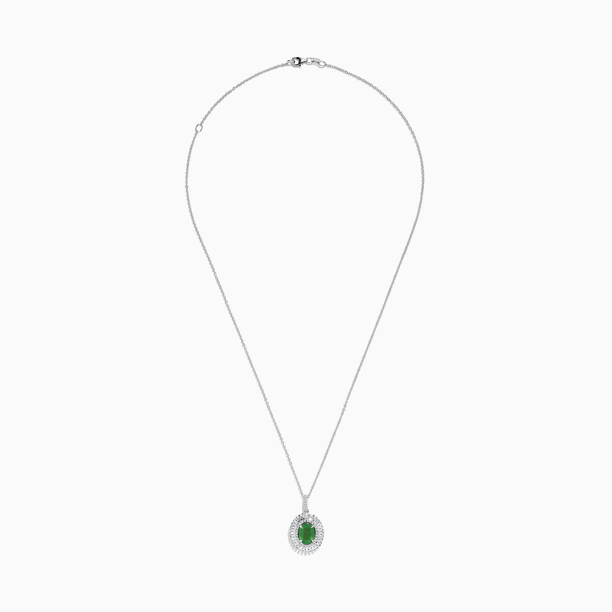 A 14K white gold pendant featuring an oval emerald, surrounded by a double halo of sparkling diamonds.