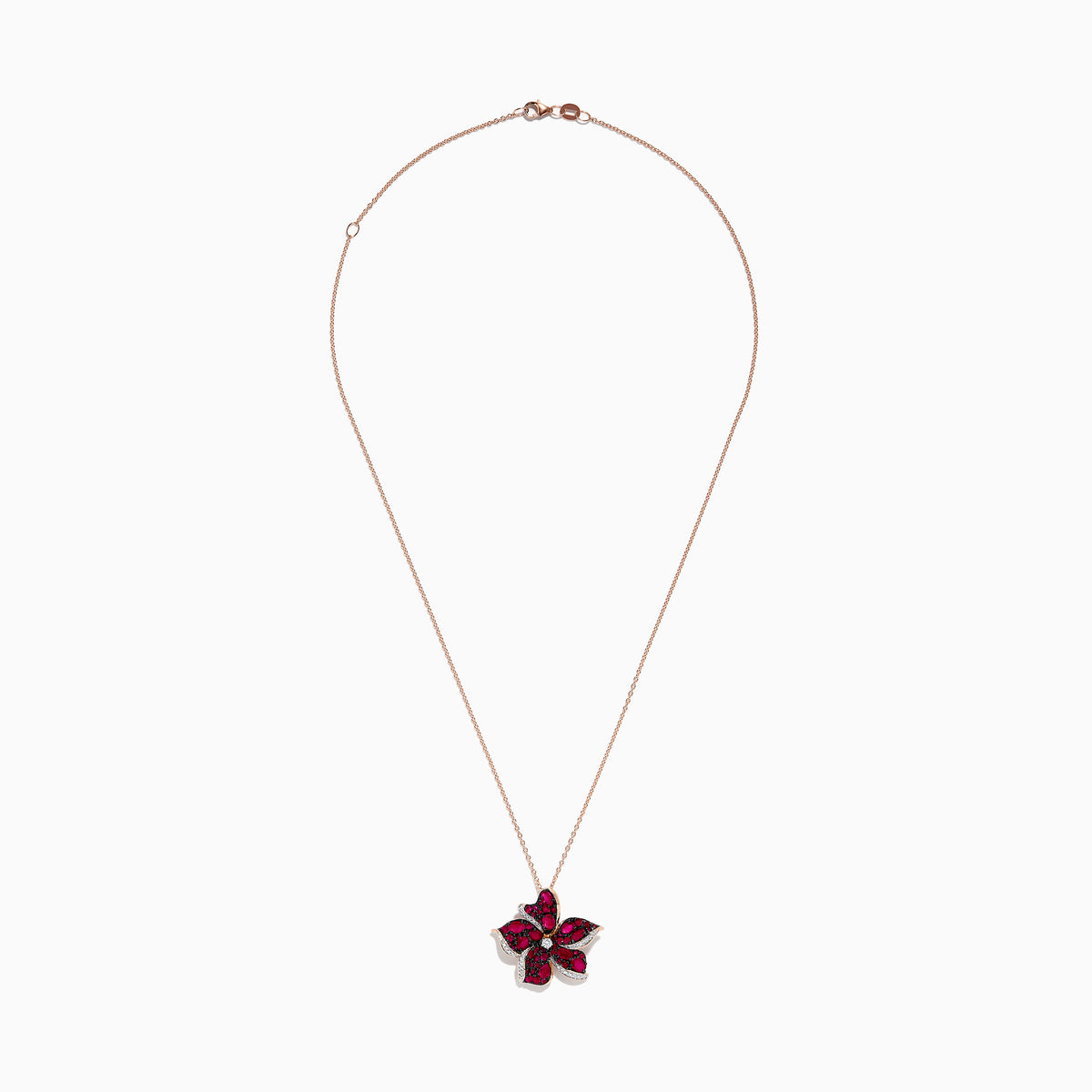 The Ruby Royale 14K Rose Gold Ruby and Diamond Flower Pendant showcases a rose gold chain with a flower-shaped design, featuring vibrant rubies, black stones, and sparkling diamonds at the center and petal edges.