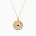 The Novelty 14K Yellow Gold White, Blue and Black Diamond Evil Eye Pendant features a round eye design at the center, highlighted by sparkling diamonds in white, blue, and black tones arranged in a circular pattern.
