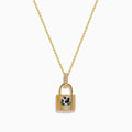 The Signature 14K Yellow Gold Diamond Lock Pendant features a jeweled panther face with green eyes, black accents, and small clear crystals on the loop, all on a yellow gold chain necklace.