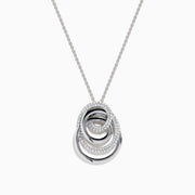 The 14K White Gold Diamond Overlapping Circle Pendant features three intertwined loops, two adorned with sparkling diamonds, suspended from a fine chain against a white background.