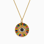 The Watercolors 14K Yellow Gold Multi Sapphire Evil Eye Pendant showcases a central eye motif encircled by vibrant, radiating sapphires in a striking sunburst design.