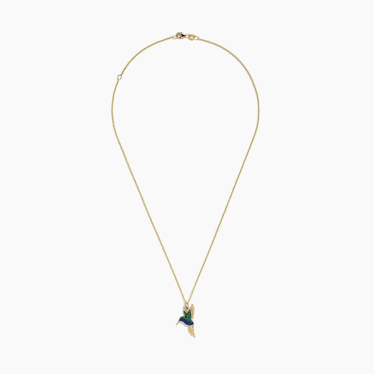 The Safari 14k Yellow Gold Emerald and Sapphire Humming Bird Pendant features a hummingbird-shaped design with emerald and sapphire accents, shown against a white background.