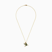 The Safari 14k Yellow Gold Tsavorite and Diamond Bird Pendant features a hummingbird design with green tsavorite and white diamonds, adding elegance to any look.