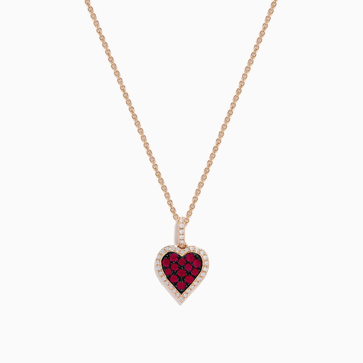 The Ruby Royale 14K Rose Gold Ruby and Diamond Heart Pendant features a ruby heart centerpiece, accented with dazzling diamonds on a rose gold chain.