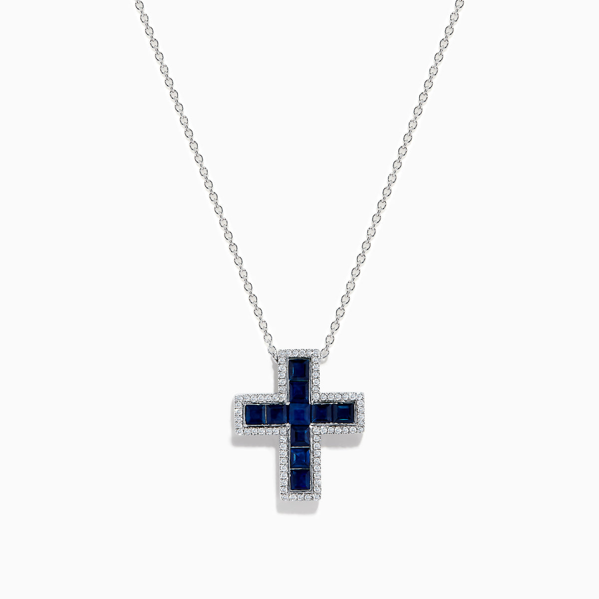The Royale Bleu 14K White Gold Sapphire and Diamond Cross Pendant features deep blue sapphires and sparkling diamonds, elegantly displayed on a plain white background.