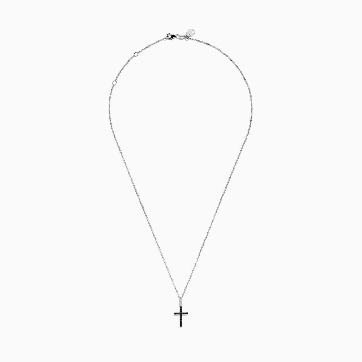 The Novelty 14K White Gold Black and White Diamond Cross Pendant features black stones and a single clear stone at the top, shown on a silver chain against a plain white background.