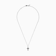 The Novelty 14K White Gold Black and White Diamond Cross Pendant features black stones and a single clear stone at the top, shown on a silver chain against a plain white background.