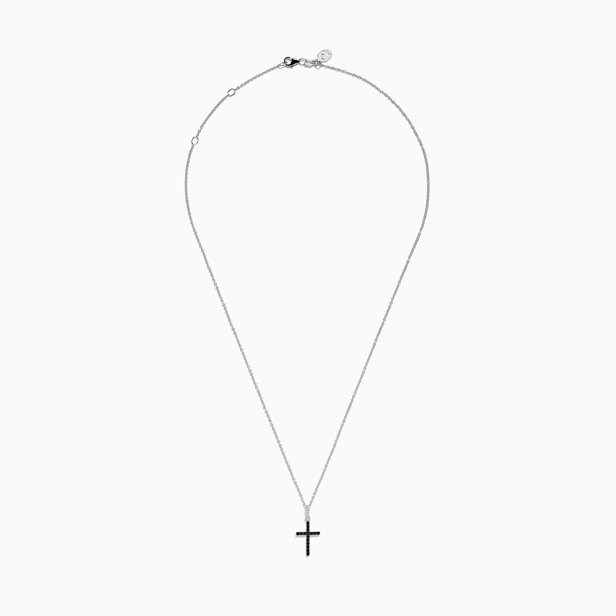 The Novelty 14K White Gold Black and White Diamond Cross Pendant features black stones and a single clear stone at the top, shown on a silver chain against a plain white background.