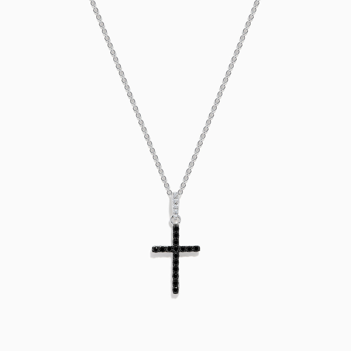 The Novelty 14K White Gold Black and White Diamond Cross Pendant features black stones and a single clear stone at the top, shown on a silver chain against a plain white background.