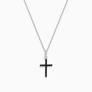 The Novelty 14K White Gold Black and White Diamond Cross Pendant features black stones and a single clear stone at the top, shown on a silver chain against a plain white background.