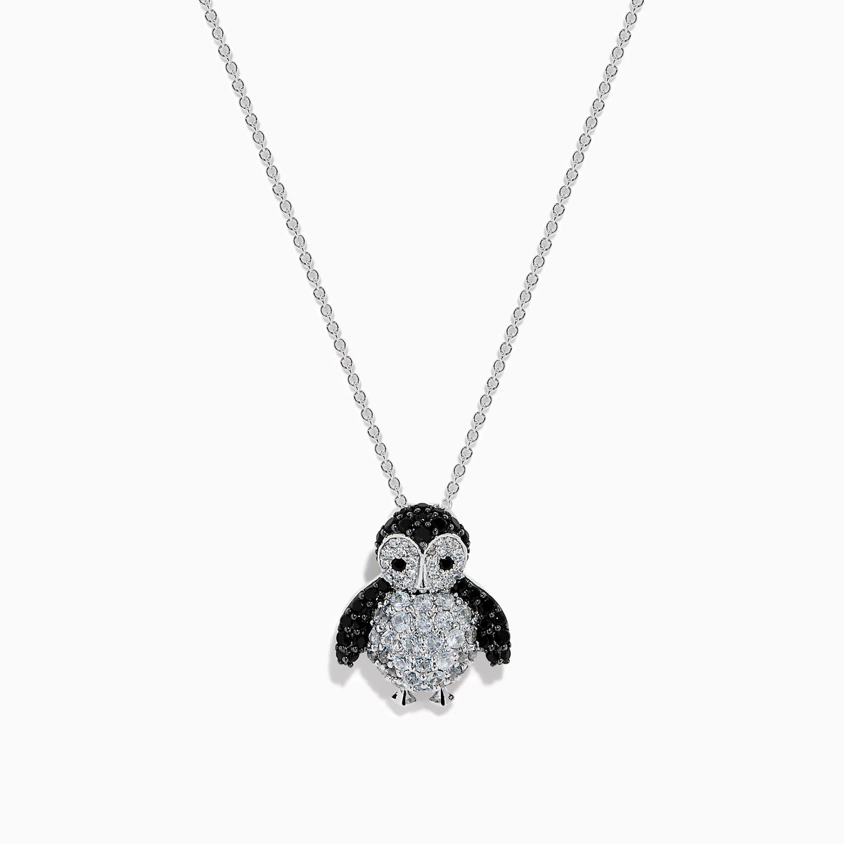 A 14K white gold necklace featuring a penguin pendant accented with diamonds, white sapphires, and black spinel.