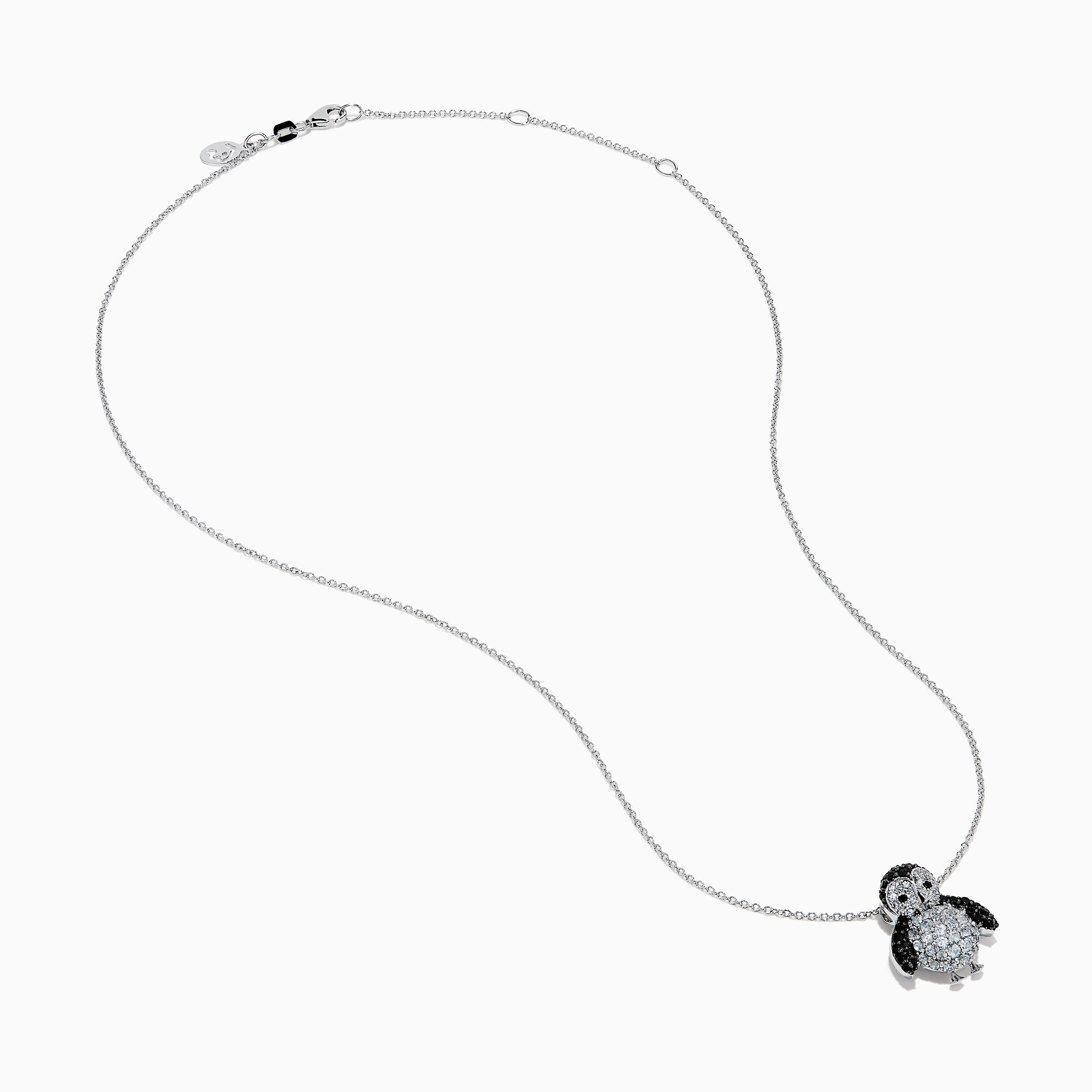 A 14K white gold necklace featuring a penguin pendant accented with diamonds, white sapphires, and black spinel.