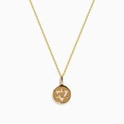 The 14K Yellow Gold Diamond Star of David Pendant features a round pendant adorned with sparkling diamonds, hanging from a delicate gold chain and showcased against a white background.