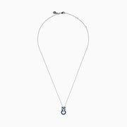 The Signature 14K White Gold Blue Sapphire and Diamond Panther Pendant showcases a diamond-studded panther head with blue and white gemstones, gripping a vivid blue sapphire pendant ring in its mouth.