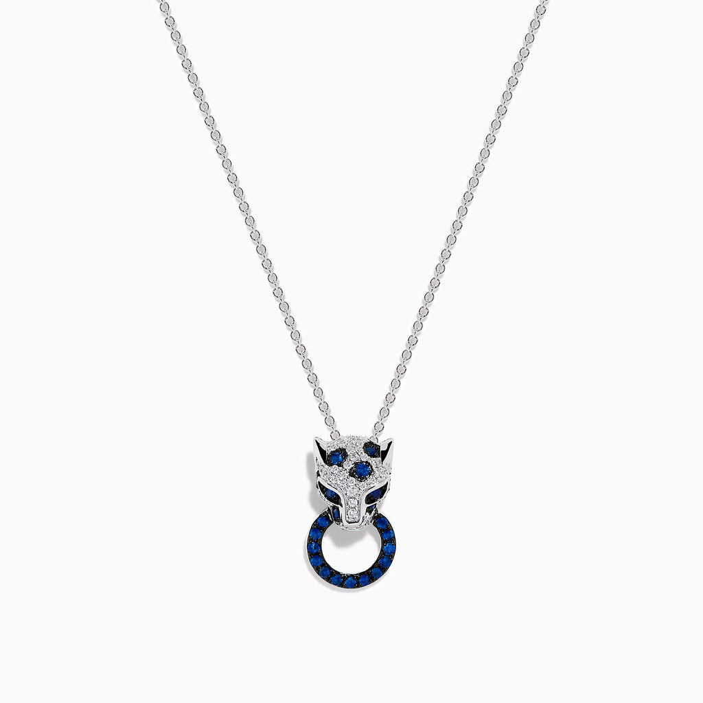 The Signature 14K White Gold Blue Sapphire and Diamond Panther Pendant showcases a diamond-studded panther head with blue and white gemstones, gripping a vivid blue sapphire pendant ring in its mouth.
