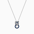 The Signature 14K White Gold Blue Sapphire and Diamond Panther Pendant showcases a diamond-studded panther head with blue and white gemstones, gripping a vivid blue sapphire pendant ring in its mouth.