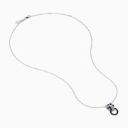 The Signature 14K White Gold Blue Sapphire and Diamond Panther Pendant showcases a diamond-studded panther head with blue and white gemstones, gripping a vivid blue sapphire pendant ring in its mouth.