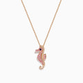 The 14K Rose Gold Pink Sapphire and Diamond Pave Seahorse Pendant features pink sapphires, diamond accents, and a small black gemstone eye, all set in rose gold and displayed against a white background.