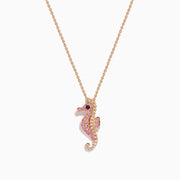 The 14K Rose Gold Pink Sapphire and Diamond Pave Seahorse Pendant features pink sapphires, diamond accents, and a small black gemstone eye, all set in rose gold and displayed against a white background.