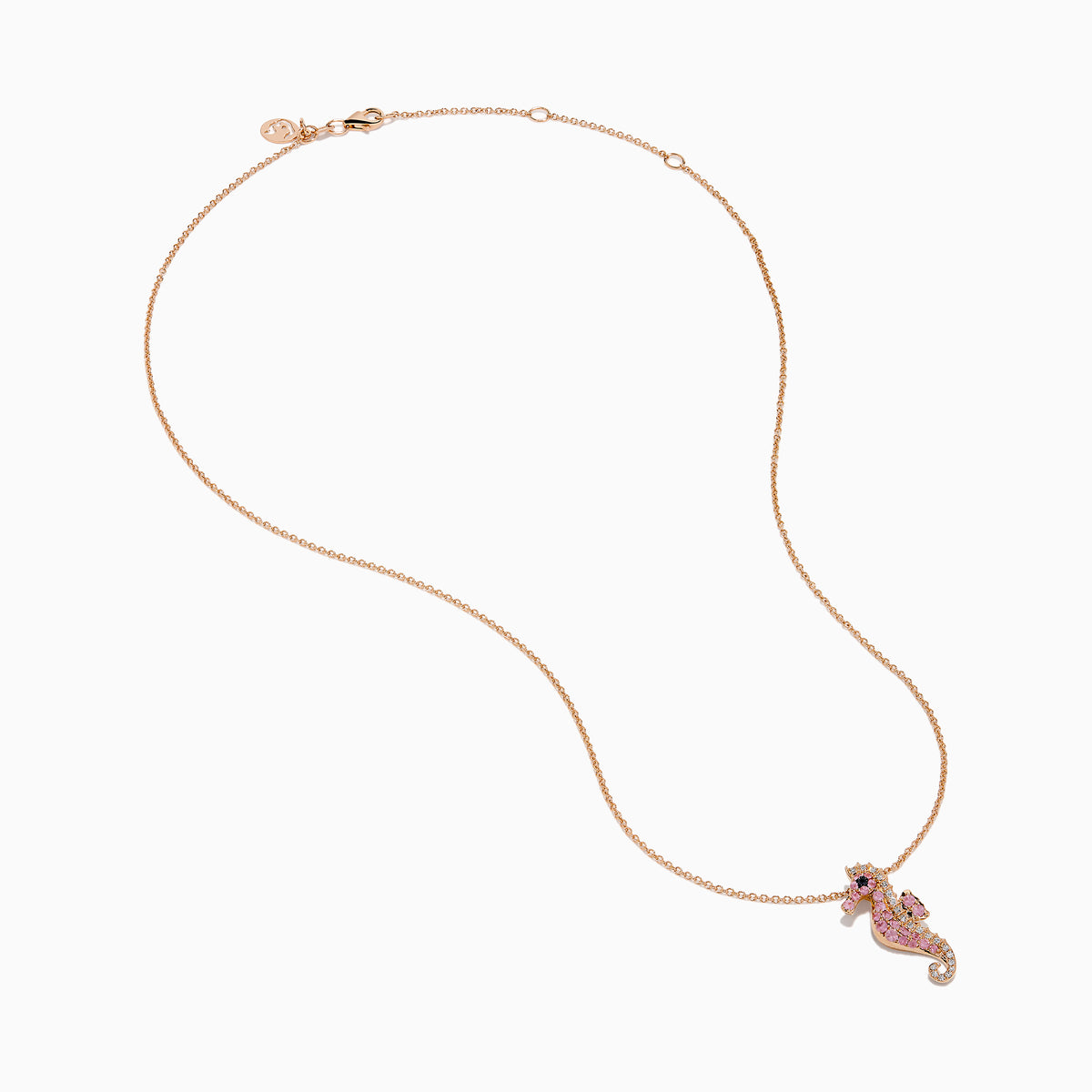 The 14K Rose Gold Pink Sapphire and Diamond Pave Seahorse Pendant features pink sapphires, diamond accents, and a small black gemstone eye, all set in rose gold and displayed against a white background.