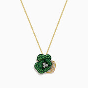 The 14K Yellow Gold Tsavorite and Diamond Flower Pendant features a floral design with one petal set with diamonds and the others adorned with vibrant green tsavorites.