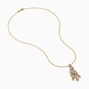 The Safari 14K Yellow Gold Diamond Peacock Pendant features an intricately detailed peacock with diamond-adorned tail feathers, suspended from a 14K yellow gold chain, shown on a white background.