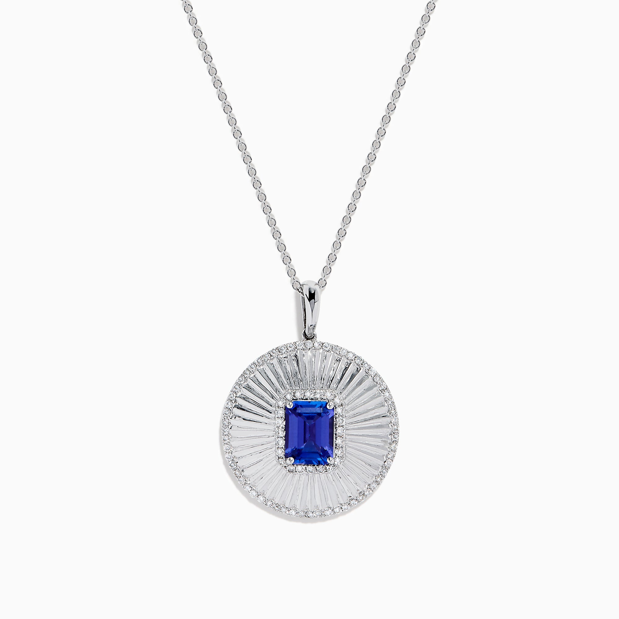 The 14K White Gold Tanzanite and Diamond Fluted Circle Pendant features a round diamond-accented design with a radiant motif and a central emerald-cut blue tanzanite stone.