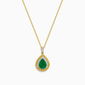 The 14K Two Tone Emerald Double Halo Pendant features a teardrop-shaped emerald accented by yellow and white diamonds on a gold chain.