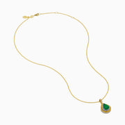 The 14K Two Tone Emerald Double Halo Pendant features a teardrop-shaped emerald accented by yellow and white diamonds on a gold chain.