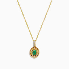 The 14K Yellow Gold Emerald and Diamond Filigree Halo Pendant features an elegant oval green emerald encircled by sparkling diamonds, with additional diamond accents on the bail for added brilliance.