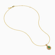 The 14K Yellow Gold Emerald and Diamond Filigree Halo Pendant features an elegant oval green emerald encircled by sparkling diamonds, with additional diamond accents on the bail for added brilliance.