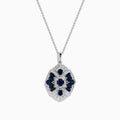 The 14K White Gold Sapphire and Diamond Vintage Pendant features deep blue sapphires and sparkling diamonds in a geometric design, suspended from a delicate white gold chain, all displayed on a white background.