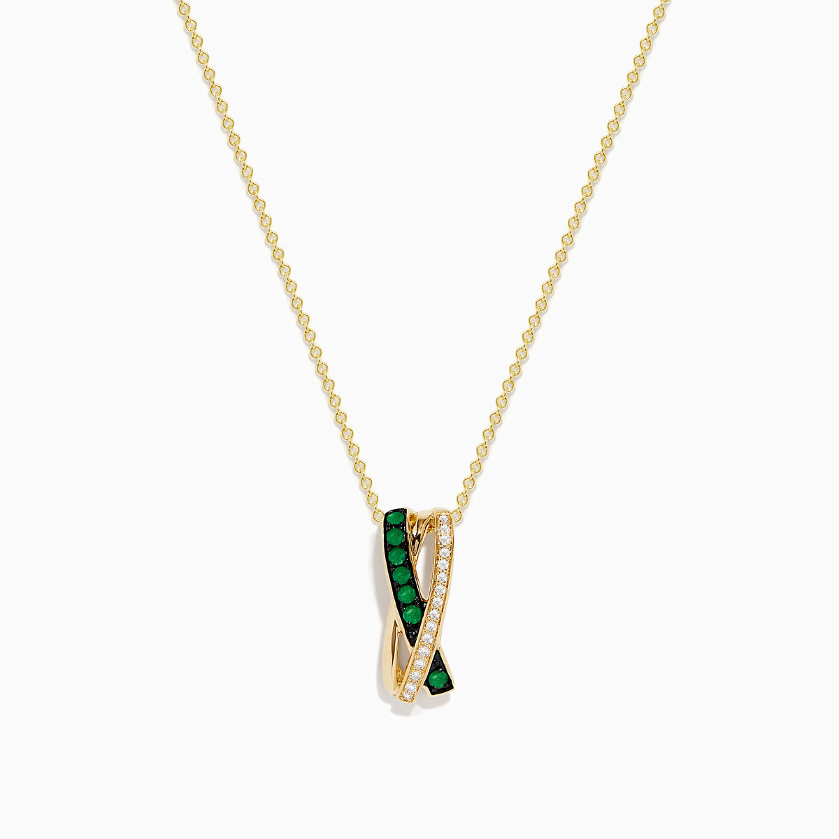 The 14K Yellow Gold Emerald and Diamond Crossover Pendant features interwoven bands—one set with emeralds, the other with sparkling diamonds—on a delicate gold chain for an elegant effect.