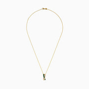 The 14K Yellow Gold Emerald and Diamond Crossover Pendant features interwoven bands—one set with emeralds, the other with sparkling diamonds—on a delicate gold chain for an elegant effect.
