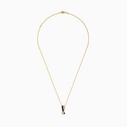The Royale Bleu 14K Yellow Gold Pendant showcases an intertwined design with a blue sapphire band and a diamond-encrusted band, set on a gold chain, elegantly displayed against a white background.