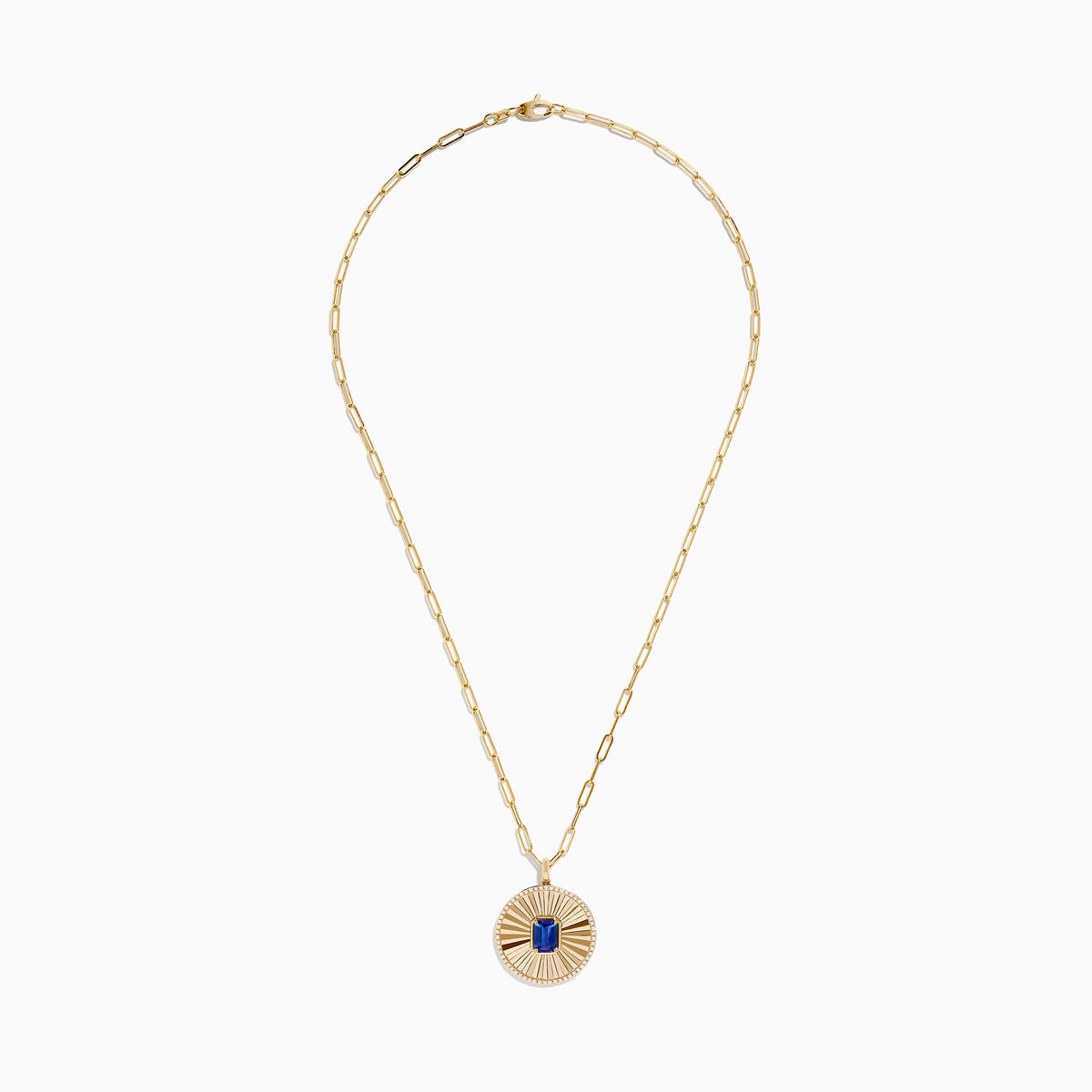The Nahla Siri 14K Yellow Gold Tanzanite and Diamond Pendant features a round sunburst design with a central blue tanzanite gemstone, accented by diamonds, on an elongated link gold chain.