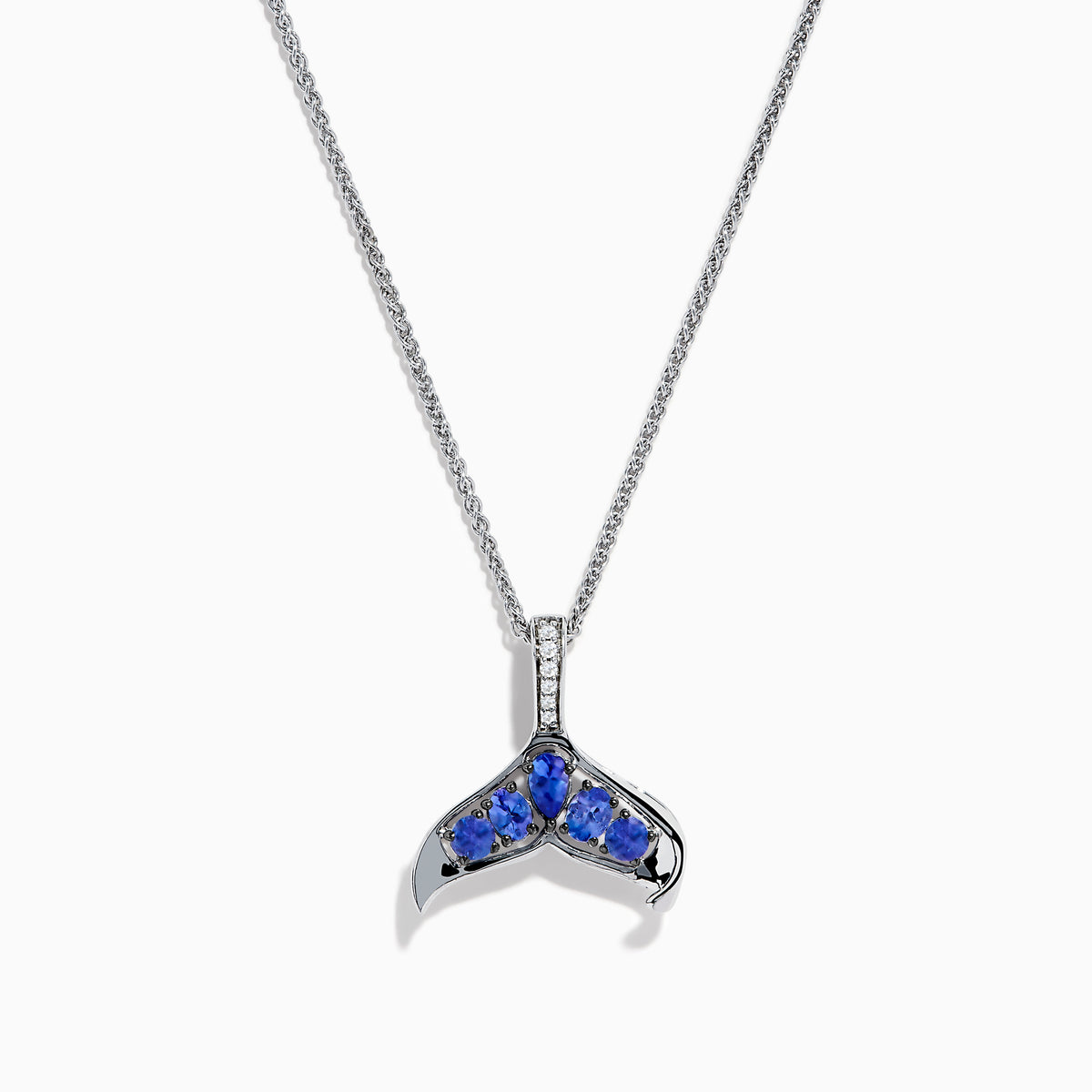 The 925 Silver Tanzanite and Diamond Whale Tail Pendant features a whale tail design with blue tanzanite gemstones and sparkling diamonds, crafted in 925 silver for a stunning shine against a white background.