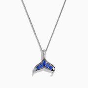 The 925 Silver Tanzanite and Diamond Whale Tail Pendant features a whale tail design with blue tanzanite gemstones and sparkling diamonds, crafted in 925 silver for a stunning shine against a white background.