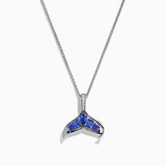 The 925 Silver Tanzanite and Diamond Whale Tail Pendant features a whale tail design with blue tanzanite gemstones and sparkling diamonds, crafted in 925 silver for a stunning shine against a white background.